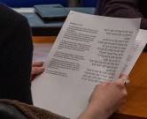 Workshop participant holds sacred text