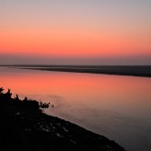 Dusk or dawn? Red sky reflected on water.